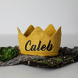 Load image into Gallery viewer, Gold knitted crown with Caleb in black lettering and gold accents
