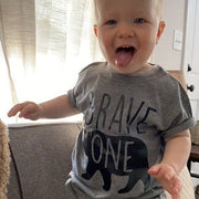 toddler boy wearing brave one shirt with tongue out