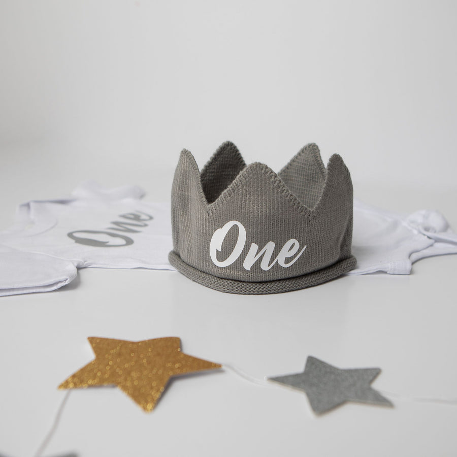 Gray knitted crown with One in white lettering