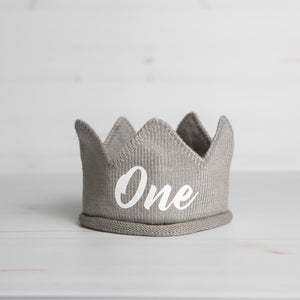 Gray knitted crown with One in white lettering