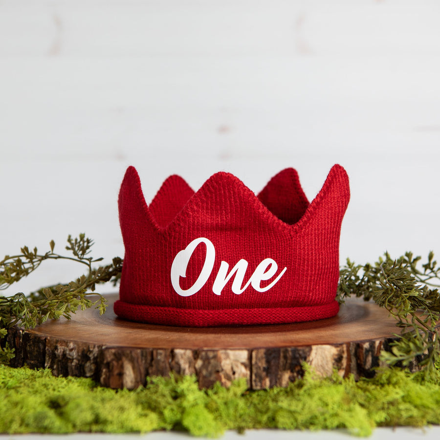 Red knitted crown with One in white lettering