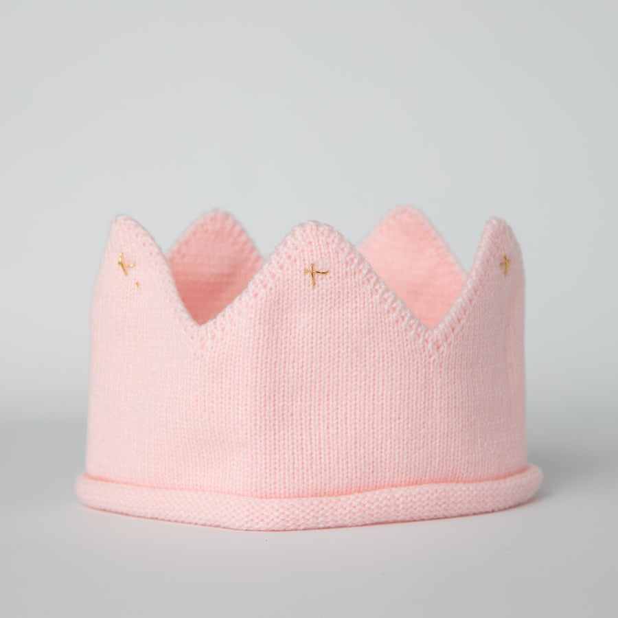 Pink knitted crown with gold accents