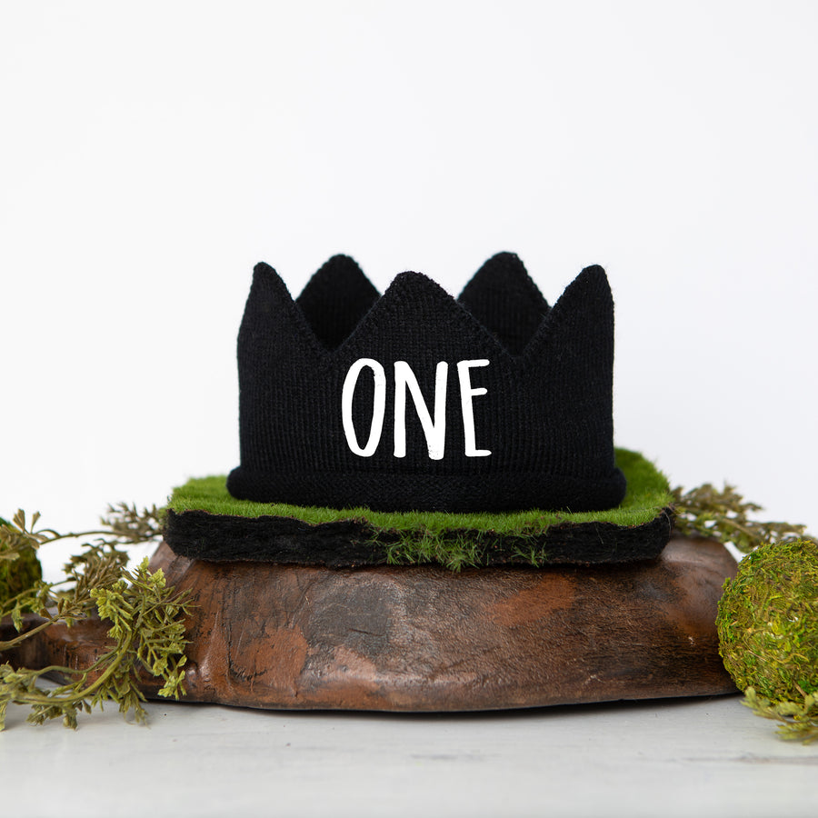 Black knitted crown with ONE in white script lettering