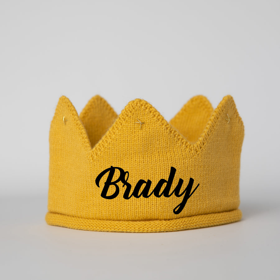 Gold knitted crown with Brady in black lettering and gold accents
