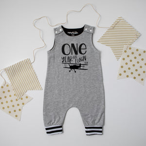 Gray "One Year Has Flown By" Airplane Themed Birthday Romper with Striped Cuff